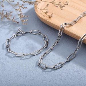 Close-up of stainless steel OT buckle necklace with twisted and polished square links