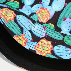 Close-up of vibrant cactus floral print and stitching on a reversible bucket hat