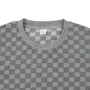 Detail of the gray checkerboard knit pattern and collar on the men's long sleeve sweatshirt