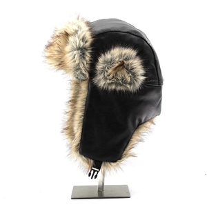 Close-up of windproof faux leather shell and thick brown fur lining of the winter hat