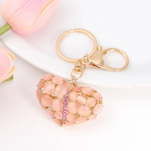 Macro shot of pink crystal heart keychain with gold frame and sparkling rhinestones