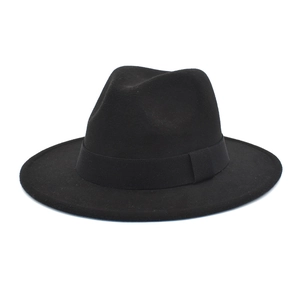 Detailed close-up of a classic black wool fedora hat with a wide brim and grosgrain ribbon