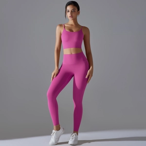 Detail view of hot pink yoga set featuring thin strap sports bra and high waist leggings