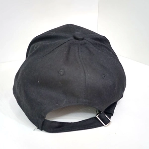 Rear view of black cotton baseball cap showing adjustable metal strap and six-panel crown