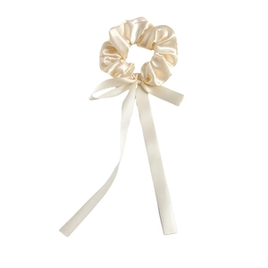 Elegant cream satin scrunchie with long bow ribbon streamers on a white background