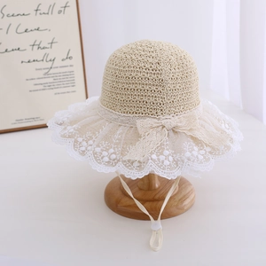 Detail of baby girl straw sun hat with white lace trim and adjustable drawstring