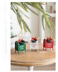 Three-piece metal Christmas mailboxes in red, white, and green with Santa letters