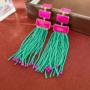 Bohemian enamel earrings with pink geometric blocks and vibrant green beaded tassels
