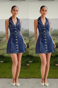 Close-up of dark blue denim dress with gold buttons and halter V-neckline details