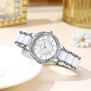 Elegant SENO white ceramic watch with rhinestone bezel on a decorative ceramic dish