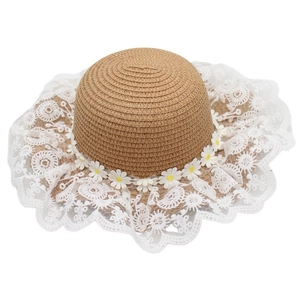 Close-up of woven straw hat featuring delicate white lace trim and daisy floral accents
