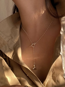 Detail of S925 sterling silver heart necklace with toggle clasp on a female model