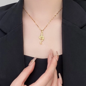 Detail shot of vintage 18K gold plated snake pendant necklace with colorful zircons