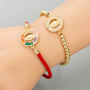 Detail of adjustable owl charm bracelet set with colorful zircons on a female wrist