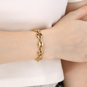 Men's hip hop gold stainless steel coffee bean chain necklace worn by a model