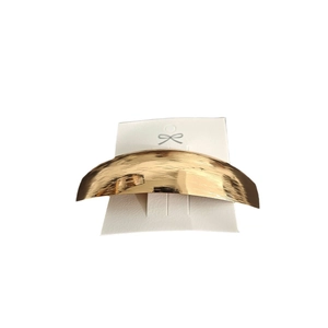 Elegant gold metallic curved hair clip for women with a minimalist geometric spring design