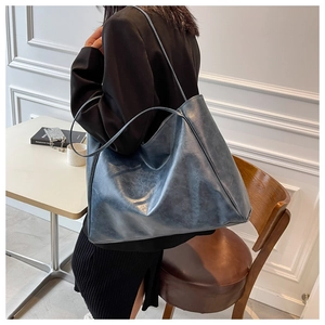 Detail of the navy blue PU leather tote bag showing vintage texture and long shoulder straps