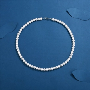 Classic single layer men's white round pearl necklace with silver clasp on blue background