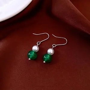 Elegant vintage jewelry set featuring pearl and emerald green beaded drop earrings
