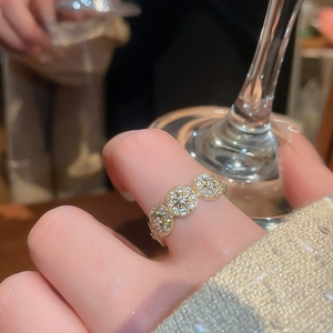 Macro view of 14k gold plated vintage ring with triple-round design and pavé zircons