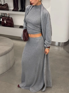 Close-up of grey ribbed knit three-piece set featuring texture on skirt and cardigan