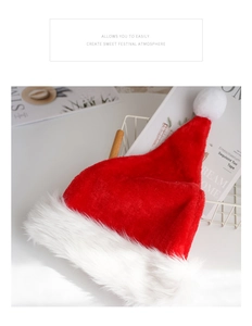 Close-up of a classic red plush Christmas hat with soft white pompom and festive texture
