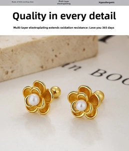 Detail of 925 sterling silver flower earrings with white pearl and gold plating