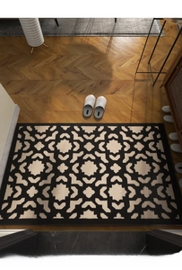 Close-up of geometric pattern entry mat with woven texture on herringbone wood floor
