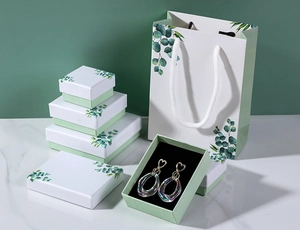 Detailed view of eucalyptus pattern jewelry gift boxes and matching paper bags