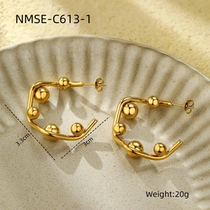 Macro shot of gold geometric C-shape earrings showing 3.3cm height and 3cm width details