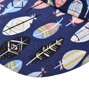 Detailed close-up of vibrant feather prints and stitching on a navy cotton baseball cap