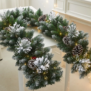 Flocked Christmas garland with pine cones, red berries and warm LED lights for home decor