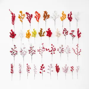Detail view of assorted artificial winterberry stems in various colors for floral decor
