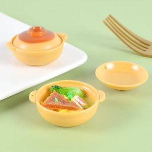 Detailed close-up of miniature clay pot seafood noodles toy with realistic resin toppings