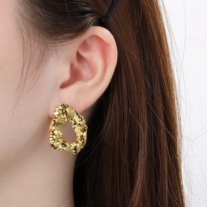 Modern irregular crumpled gold earrings featuring a hollow round design for a trendy look