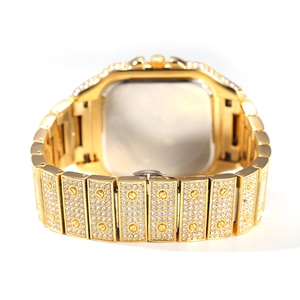 Macro view of gold iced-out square watch back with screw details and folding clasp