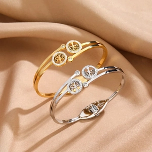 Detail of gold and silver Tree of Life stainless steel bangles with sparkling crystals