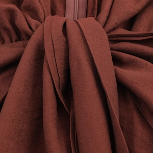 Women's V-neck brick red dress featuring long sleeves and an elegant waist knot design