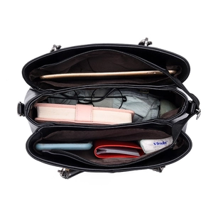 Black leather multi-layer tote bag with spacious interior compartments and tablet storage