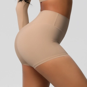 Detail view of high-waisted nude yoga shorts featuring seamless fit and butt-lifting design