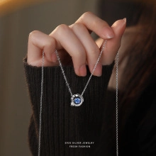 Macro shot of S925 sterling silver necklace with deep blue round gemstone pendant