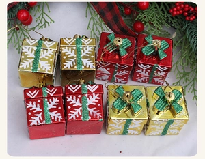 Close-up of glittery Christmas tree gift box ornaments with snowflake and ribbon patterns