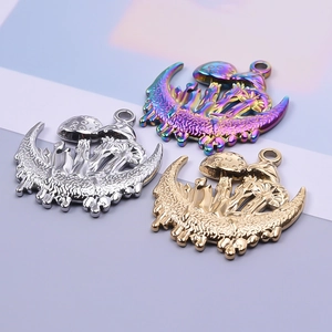 Detail of mushroom and moon pendants in gold, silver and rainbow stainless steel finishes