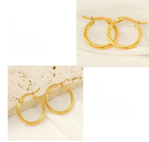 Detailed view of gold plated titanium steel hoop earrings with elegant spiral texture