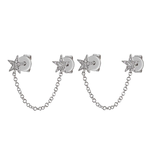Close-up of silver star earrings with cubic zirconia and connecting chain link detail