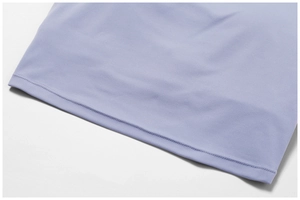 Detail view of double-stitched hem on lavender yoga wear with smooth breathable fabric
