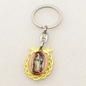 Close-up of Virgin Mary keychain featuring a golden braided frame and silver metal ring