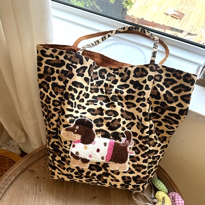 Detailed view of the leopard print tote bag featuring a cute cartoon dog towel embroidery