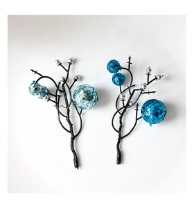 Close-up of artificial Christmas branches with blue glitter sequins and silver foam berries