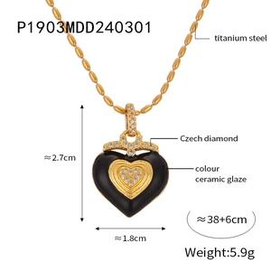 Detail view of heart pendant with black ceramic glaze and Czech diamonds on gold chain